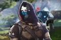 A close-up shot of Cayde-6 and Zavala's Ghost Targe from Destiny 2 The Final Shape next to each other, placed above a blurred background of a camp in a wooded area of the Pale Heart.