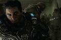 Young Marcus Fenix from Gears of War E-Day in armor getting attacked by a Locust Drone
