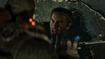 Gears of War E-Day character fights off a Locust.